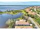 Aerial view of property showcasing pool, lakefront location and community at 4233 Grosse Pointe Dr, Port Charlotte, FL 33953