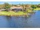 Aerial view of house with pool, situated on the lake at 4233 Grosse Pointe Dr, Port Charlotte, FL 33953