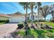 One-story house with white garage door and landscaping, showcasing its curb appeal at 4233 Grosse Pointe Dr, Port Charlotte, FL 33953