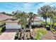 Single-story home with tile roof, palm trees, and a brick driveway, offering curb appeal at 4233 Grosse Pointe Dr, Port Charlotte, FL 33953