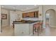 Eat-in kitchen, featuring wood cabinets and granite countertops at 4233 Grosse Pointe Dr, Port Charlotte, FL 33953