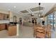 Open concept kitchen with an island, breakfast bar, and views into the living room and backyard at 4233 Grosse Pointe Dr, Port Charlotte, FL 33953