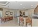 Eat-in kitchen with wood cabinetry, breakfast bar, and access to dining area at 4233 Grosse Pointe Dr, Port Charlotte, FL 33953