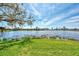 Peaceful lake view with mature trees and homes at 4233 Grosse Pointe Dr, Port Charlotte, FL 33953
