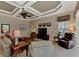 Living room features a coffered ceiling, comfortable seating, and views of the backyard at 4233 Grosse Pointe Dr, Port Charlotte, FL 33953