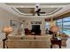 Living room boasts a coffered ceiling, large windows, and comfortable seating at 4233 Grosse Pointe Dr, Port Charlotte, FL 33953