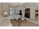 Bright living room features neutral colors, a large window, and access to kitchen and other rooms at 4233 Grosse Pointe Dr, Port Charlotte, FL 33953