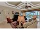 Relaxing living area with coffered ceiling, comfortable seating, and access to a patio at 4233 Grosse Pointe Dr, Port Charlotte, FL 33953