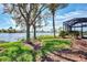 Scenic waterfront view with lush green landscaping and trees at 4233 Grosse Pointe Dr, Port Charlotte, FL 33953