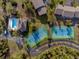 Aerial view showing community pool, tennis courts, and buildings at 4260 Placida Rd # 12C, Englewood, FL 34224
