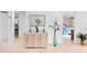 Light and airy entryway with decorative console table and tall vase at 4260 Placida Rd # 12C, Englewood, FL 34224