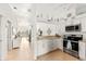 Bright kitchen features white cabinets, stainless steel appliances, and granite countertops at 4260 Placida Rd # 12C, Englewood, FL 34224