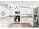 Modern white kitchen with stainless steel appliances at 4260 Placida Rd # 12C, Englewood, FL 34224
