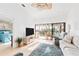 Living room with balcony access, comfy seating, and a large TV at 4260 Placida Rd # 12C, Englewood, FL 34224