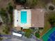 Community pool with surrounding lounge chairs and patio area at 4260 Placida Rd # 12C, Englewood, FL 34224