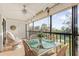 Peaceful screened balcony with outdoor seating at 4260 Placida Rd # 12C, Englewood, FL 34224