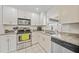 Modern kitchen features stainless steel appliances and granite countertops at 4490 Gillot Blvd, Port Charlotte, FL 33981