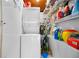 Stackable washer and dryer in laundry room with storage shelves at 45 Friendship Ln, Englewood, FL 34223