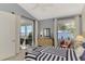 Bright bedroom with water views and a comfortable bed with striped bedding at 4628 Club Dr # H201, Port Charlotte, FL 33953