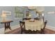 Elegant dining room with a round table, neutral decor, and kitchen views at 4628 Club Dr # H201, Port Charlotte, FL 33953