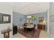 Charming dining room with light blue walls, a round table, and decorative rug at 4628 Club Dr # H201, Port Charlotte, FL 33953