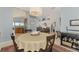 Spacious dining room features a round table and an open concept to the living room at 4628 Club Dr # H201, Port Charlotte, FL 33953