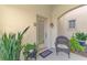 Inviting entryway with wicker chair and potted plants at 4628 Club Dr # H201, Port Charlotte, FL 33953