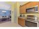 Kitchen with stainless steel appliances and yellow walls at 4628 Club Dr # H201, Port Charlotte, FL 33953