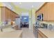 Modern kitchen with light wood cabinets and stainless steel appliances at 4628 Club Dr # H201, Port Charlotte, FL 33953