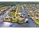 Aerial view of waterfront homes and community with lush landscaping and canal at 5231 Conner Ter, Port Charlotte, FL 33981