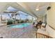 Resort-style pool with covered patio, comfortable seating, and canal views at 5231 Conner Ter, Port Charlotte, FL 33981