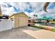 Exterior storage shed with white fence and canal view at 5231 Conner Ter, Port Charlotte, FL 33981