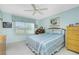 Serene bedroom with light blue walls, double bed, and ceiling fan at 5725 Greenwood Ave # 6204, North Port, FL 34287