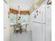 Cozy kitchen nook with small table and chairs at 5725 Greenwood Ave # 6204, North Port, FL 34287