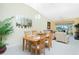 Bright dining area with wood table and chairs near living room at 5725 Greenwood Ave # 6204, North Port, FL 34287