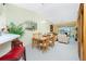 Charming dining area with a wood table and chairs, overlooking the living room at 5725 Greenwood Ave # 6204, North Port, FL 34287