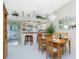 Open dining room with a wood table and chairs, and kitchen view at 5725 Greenwood Ave # 6204, North Port, FL 34287