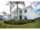 Building exterior with lush landscaping and palm trees at 5725 Greenwood Ave # 6204, North Port, FL 34287