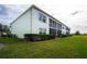Exterior view of building showcasing landscaping and green grass at 5725 Greenwood Ave # 6204, North Port, FL 34287