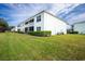 Building exterior showcasing manicured lawn and lush landscaping at 5725 Greenwood Ave # 6204, North Port, FL 34287