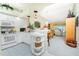 Bright kitchen with white cabinets, breakfast bar, and view to living room at 5725 Greenwood Ave # 6204, North Port, FL 34287