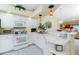 White kitchen with appliances, breakfast bar, and open layout at 5725 Greenwood Ave # 6204, North Port, FL 34287