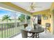 Bright lanai with glass enclosure, wicker furniture, and view of lush greenery at 5725 Greenwood Ave # 6204, North Port, FL 34287