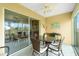 Relaxing lanai with glass doors, wicker furniture, and view of the golf course at 5725 Greenwood Ave # 6204, North Port, FL 34287