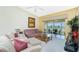Spacious living room with comfortable seating and a view of the patio at 5725 Greenwood Ave # 6204, North Port, FL 34287