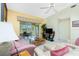 Comfortable living room with striped sofas and access to a patio at 5725 Greenwood Ave # 6204, North Port, FL 34287