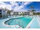 Inviting community pool with surrounding lounge chairs at 5725 Greenwood Ave # 6204, North Port, FL 34287