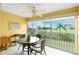 Bright sunroom with table and chairs and view at 5725 Greenwood Ave # 6204, North Port, FL 34287