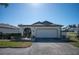 House exterior with landscaped yard and driveway at 601 Linden Dr, Englewood, FL 34223