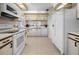 Kitchen with white appliances and ample cabinet space at 601 Linden Dr, Englewood, FL 34223